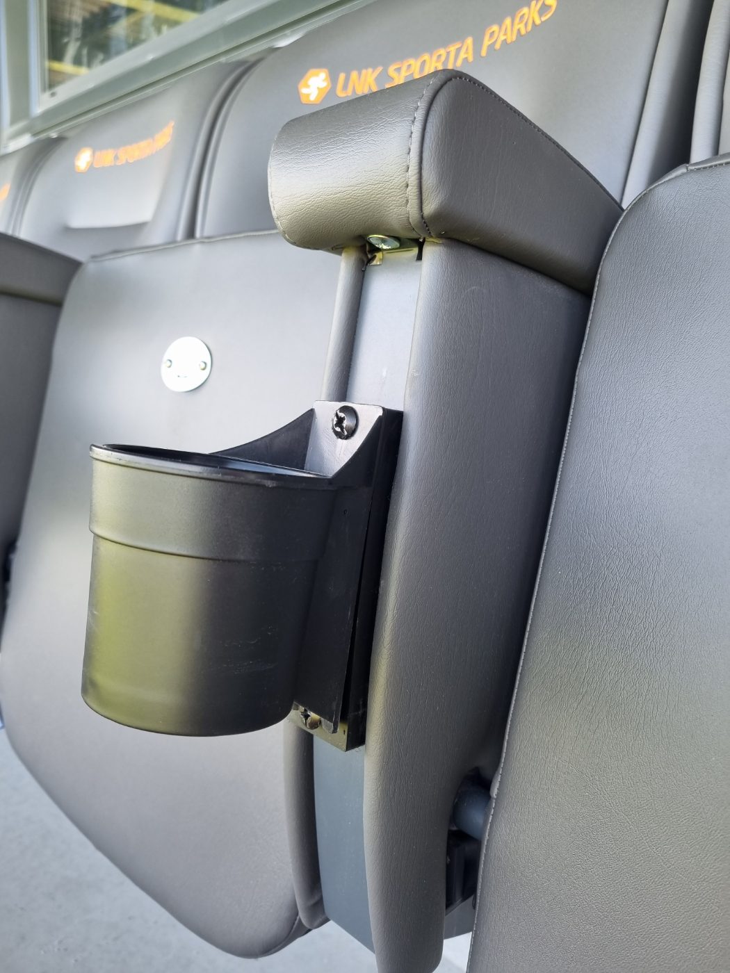 Stadium seat with integrated cupholder