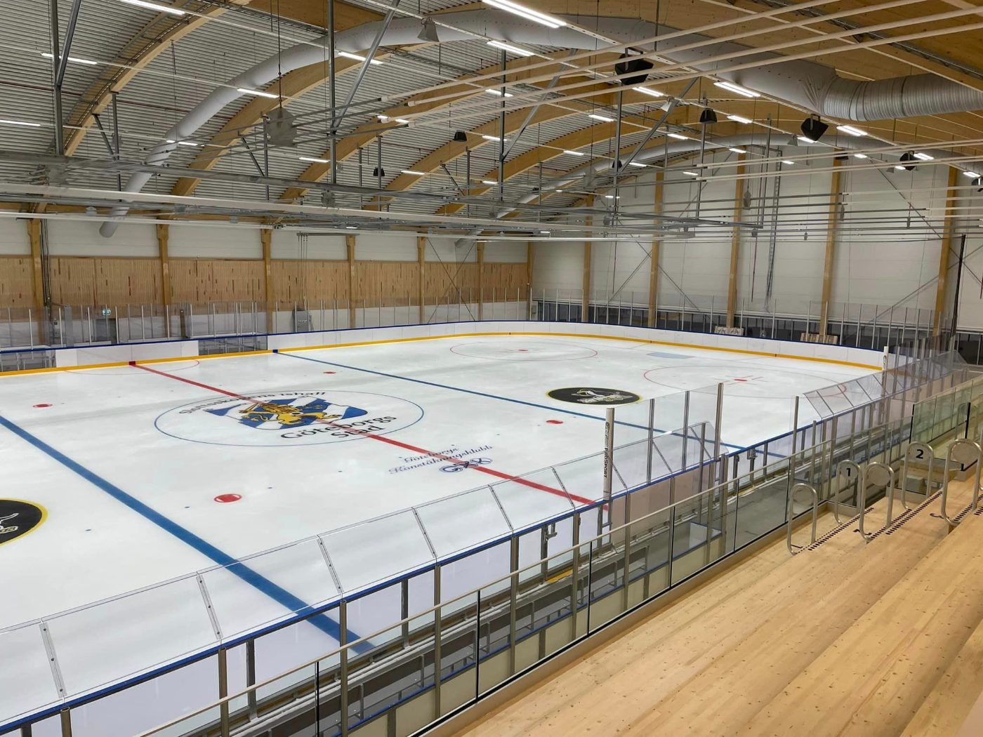 Overhead view of indoor hockey rink with full dasherboard ring