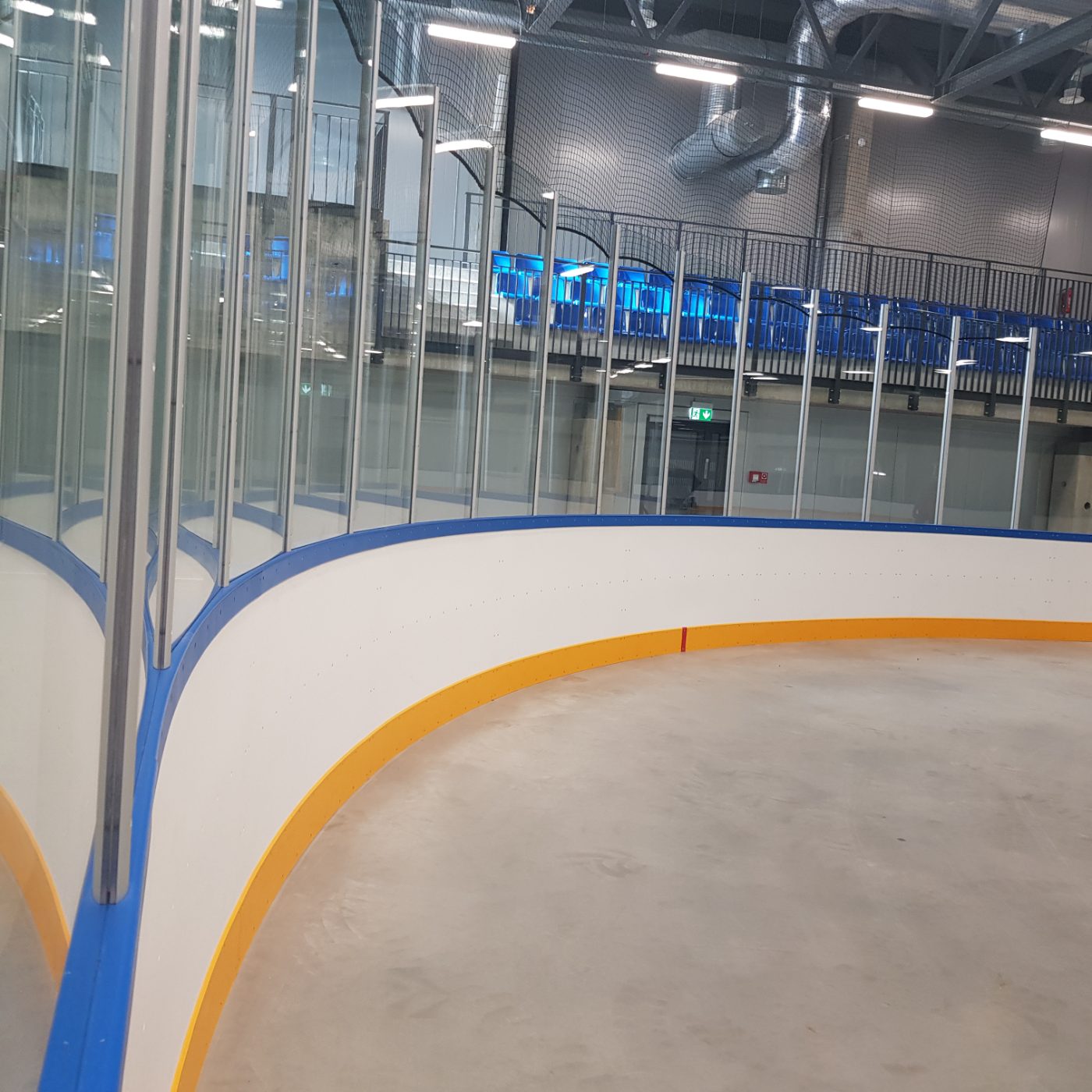 Curved corner dasherboards with blue and yellow trim
