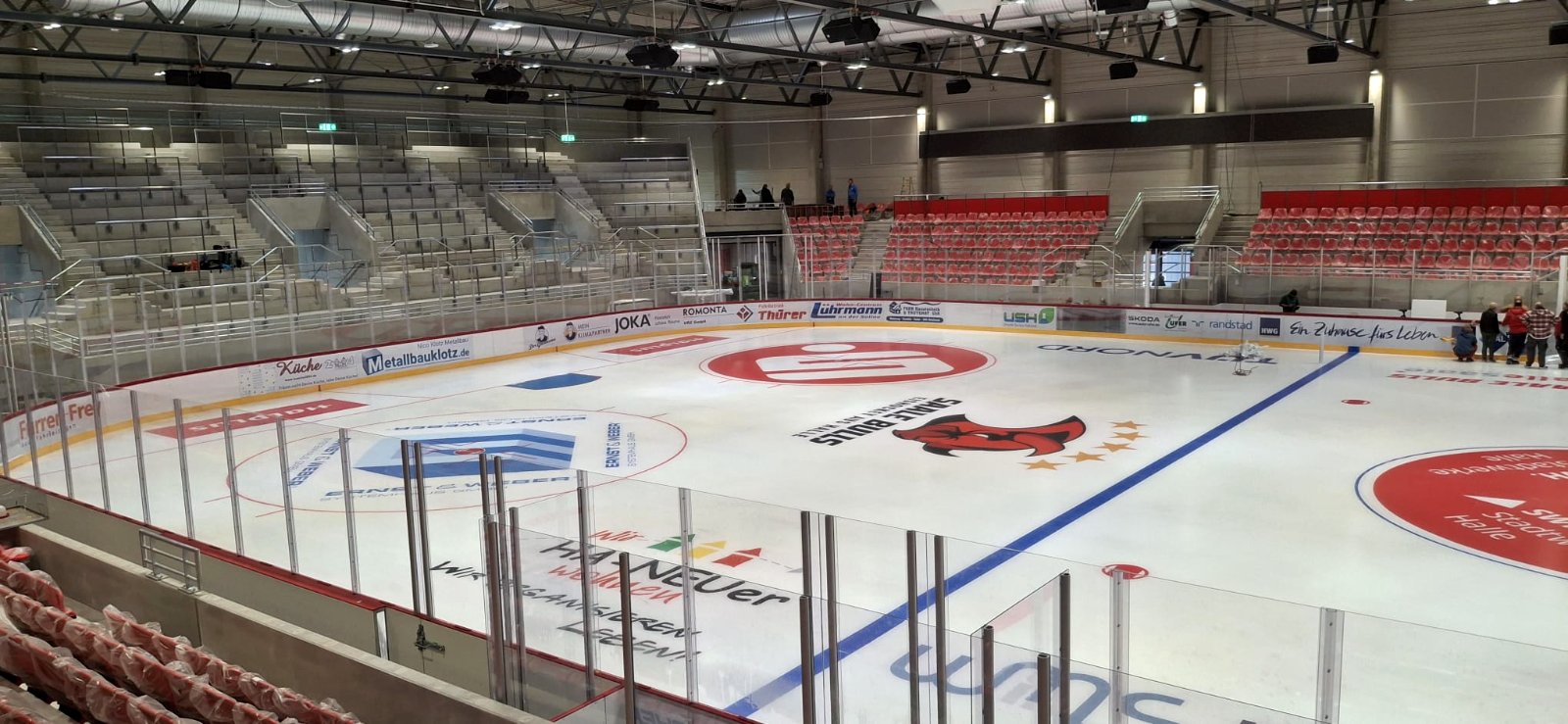 SWE Stadthalle arena rink with red spectator seating and dasherboards