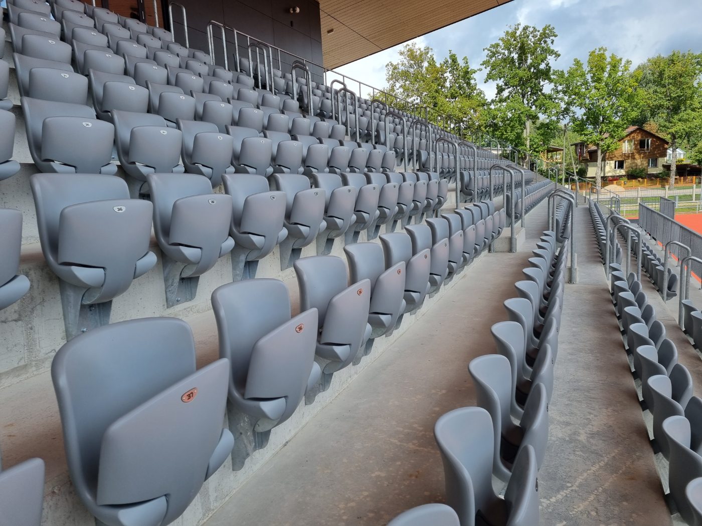 Grey outdoor stadium seats and grandstand