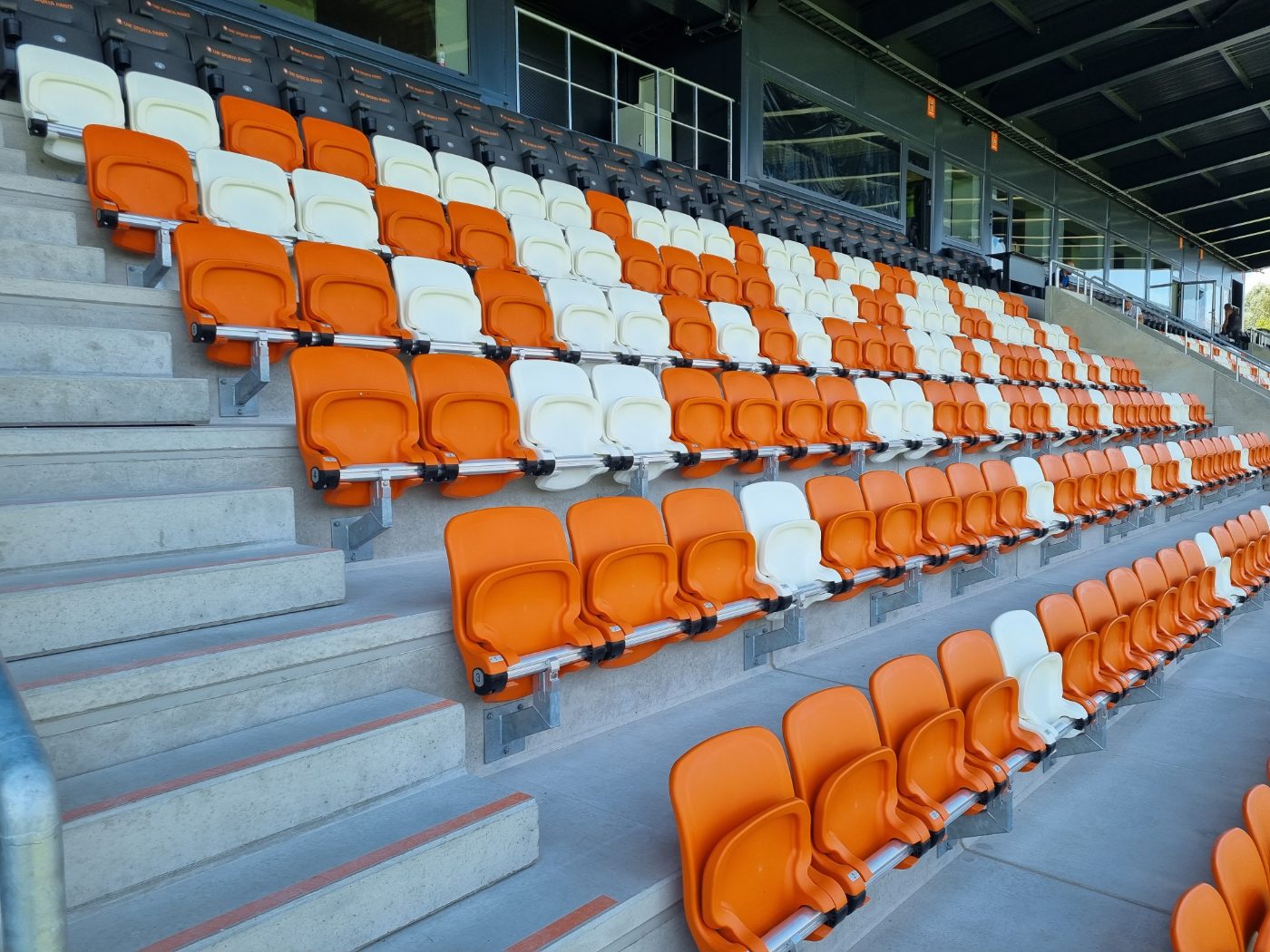 Orange and white outdoor stadium seating rows