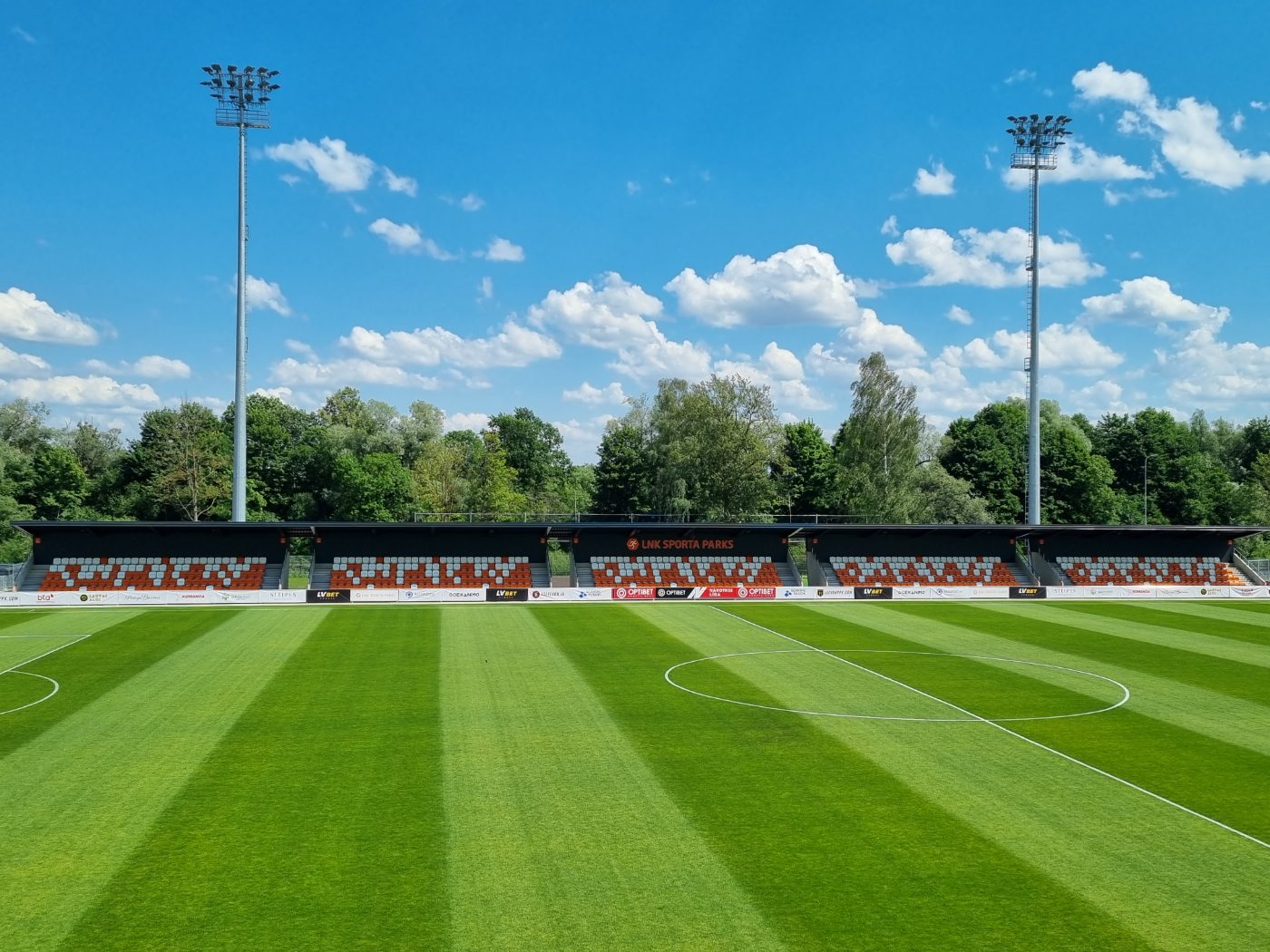 Football pitch with outdoor stadium seating in background